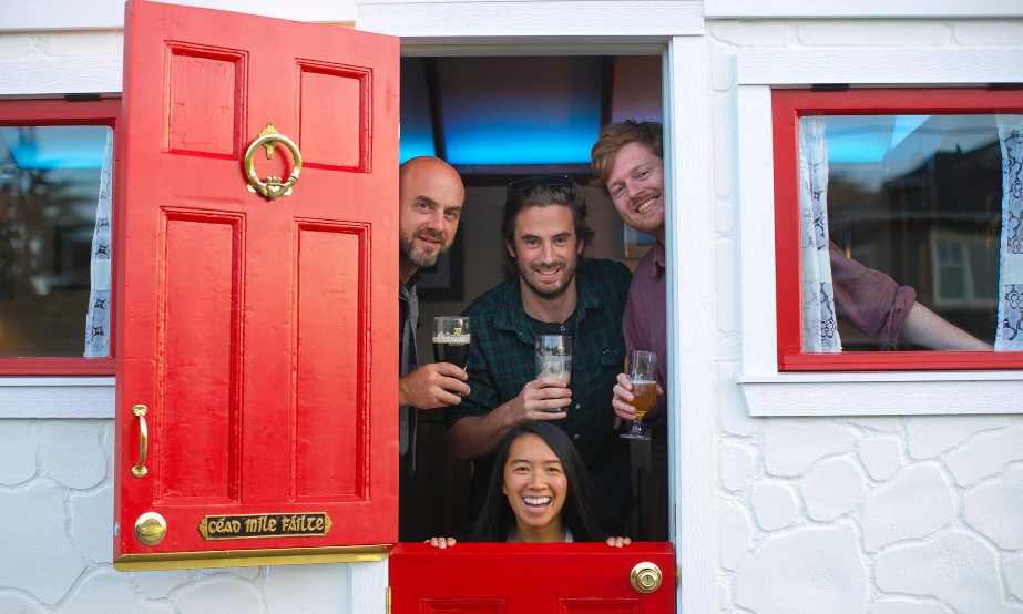 Patrons at the door of The Wild Rover.